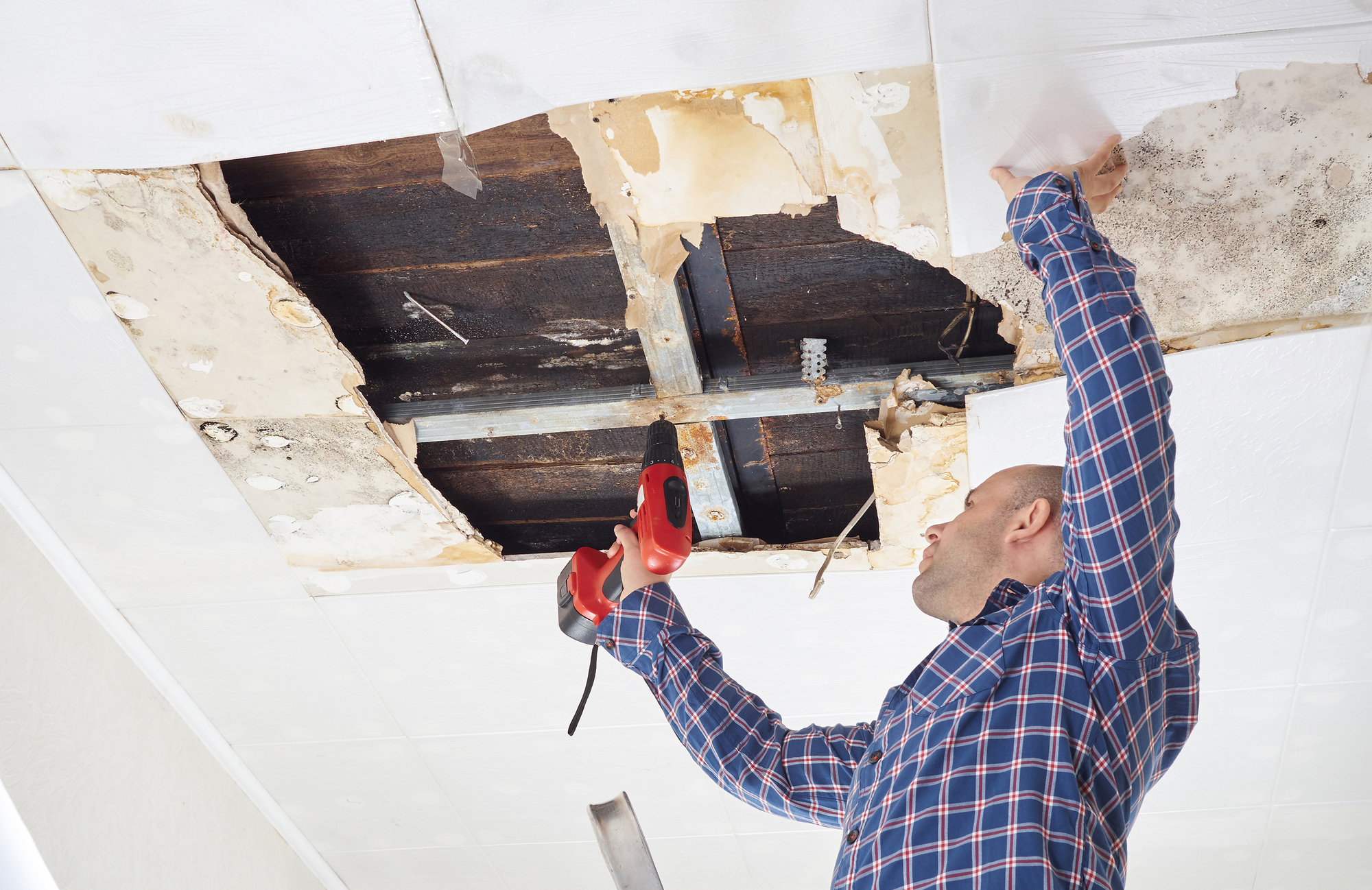 Man Repairing Collapsed Ceiling